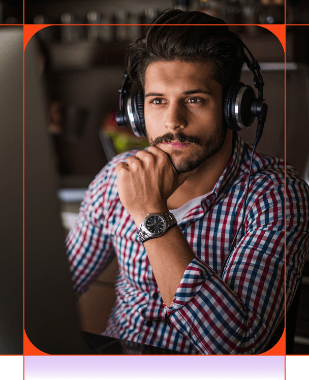 Thoughtful man in headphones and a plaid shirt, hand under chin.