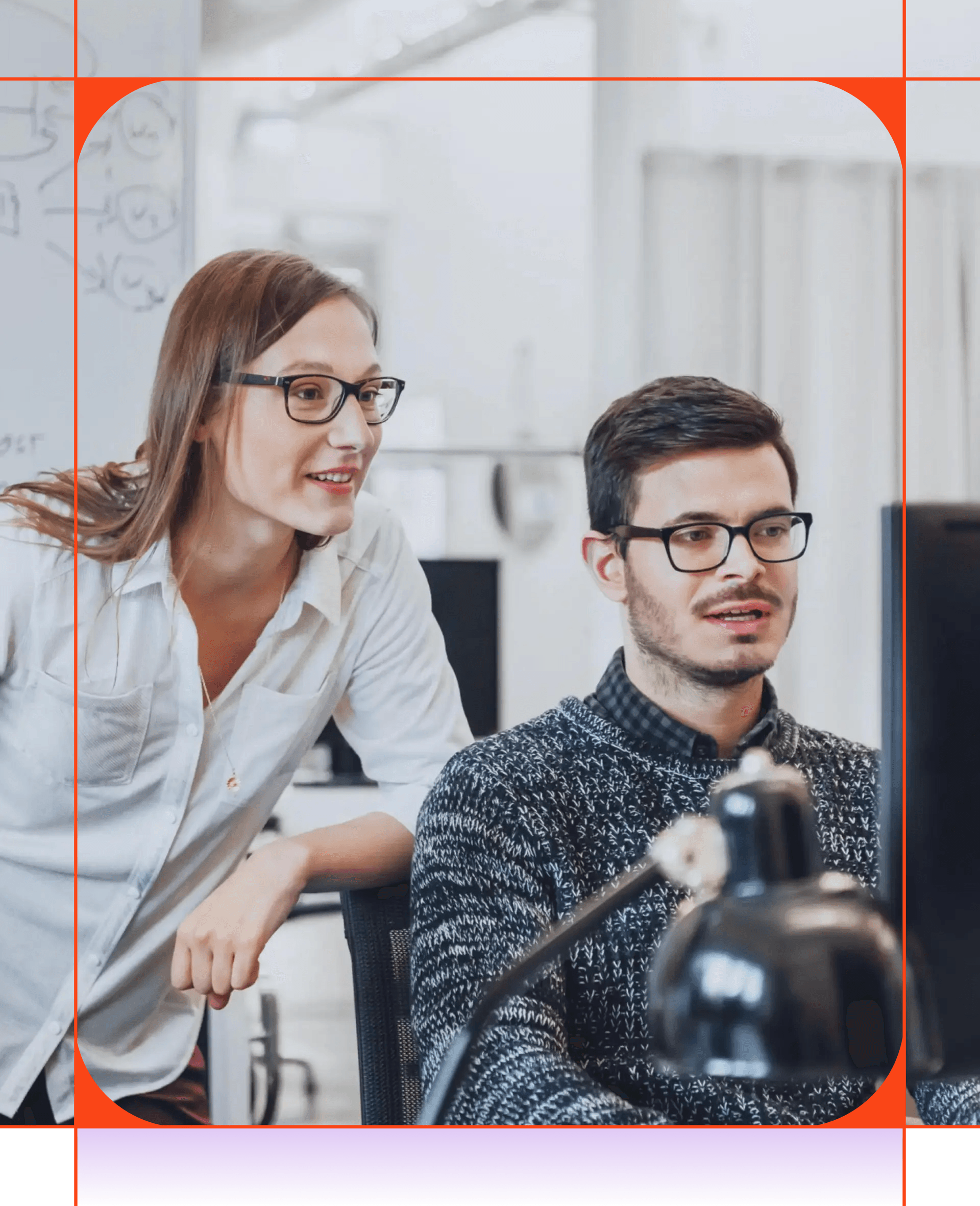 Two colleagues collaborating at a computer.