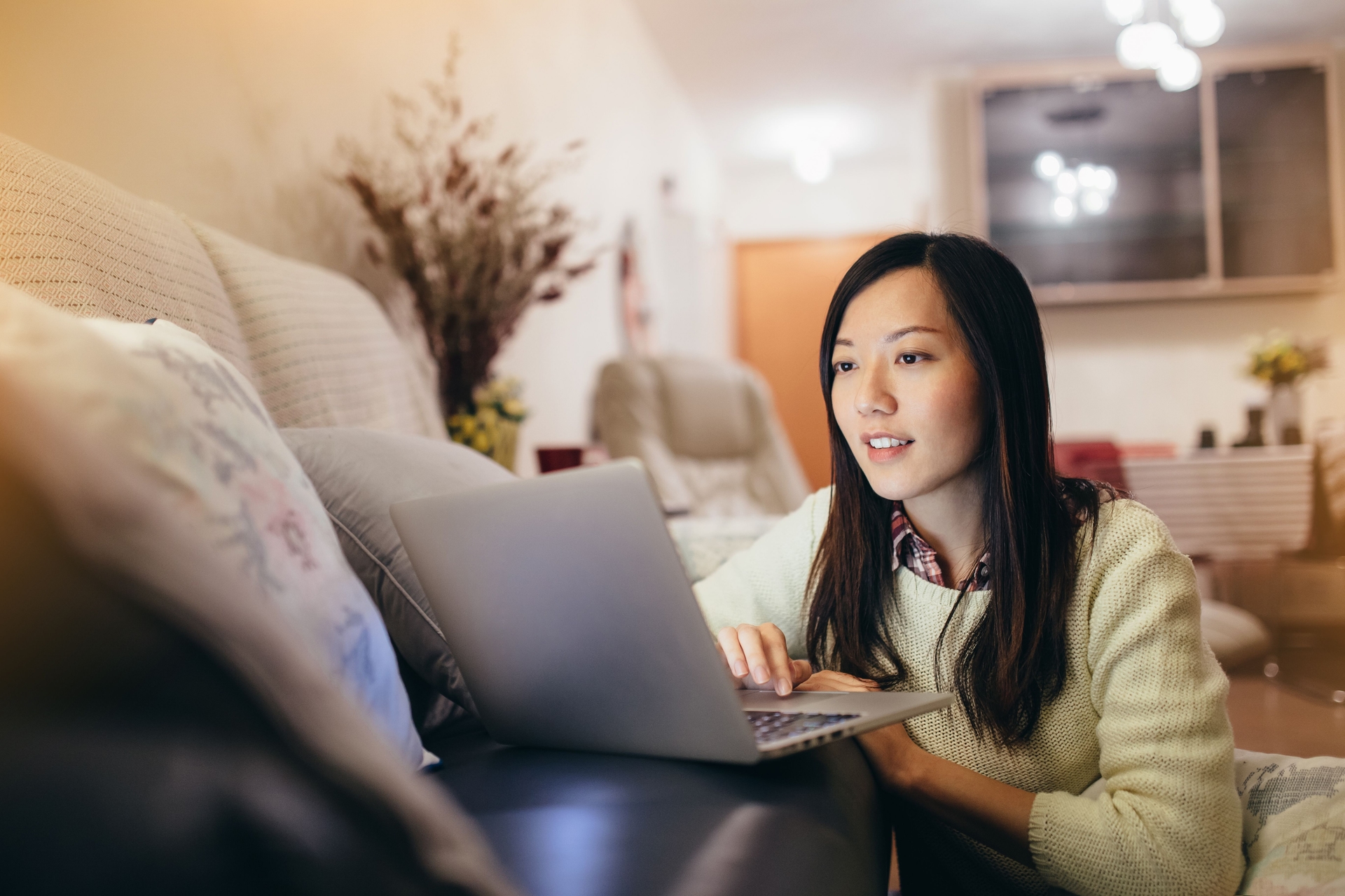 Image of a woman looking at a laptop.