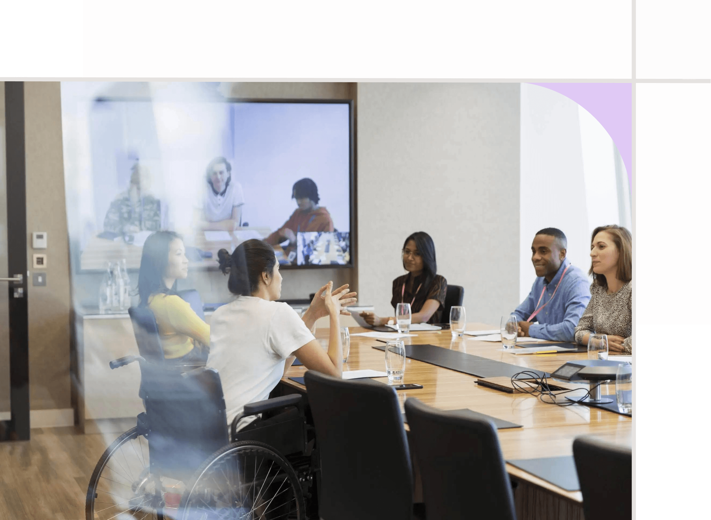 Group of coworkers sitting inside of a conference room.