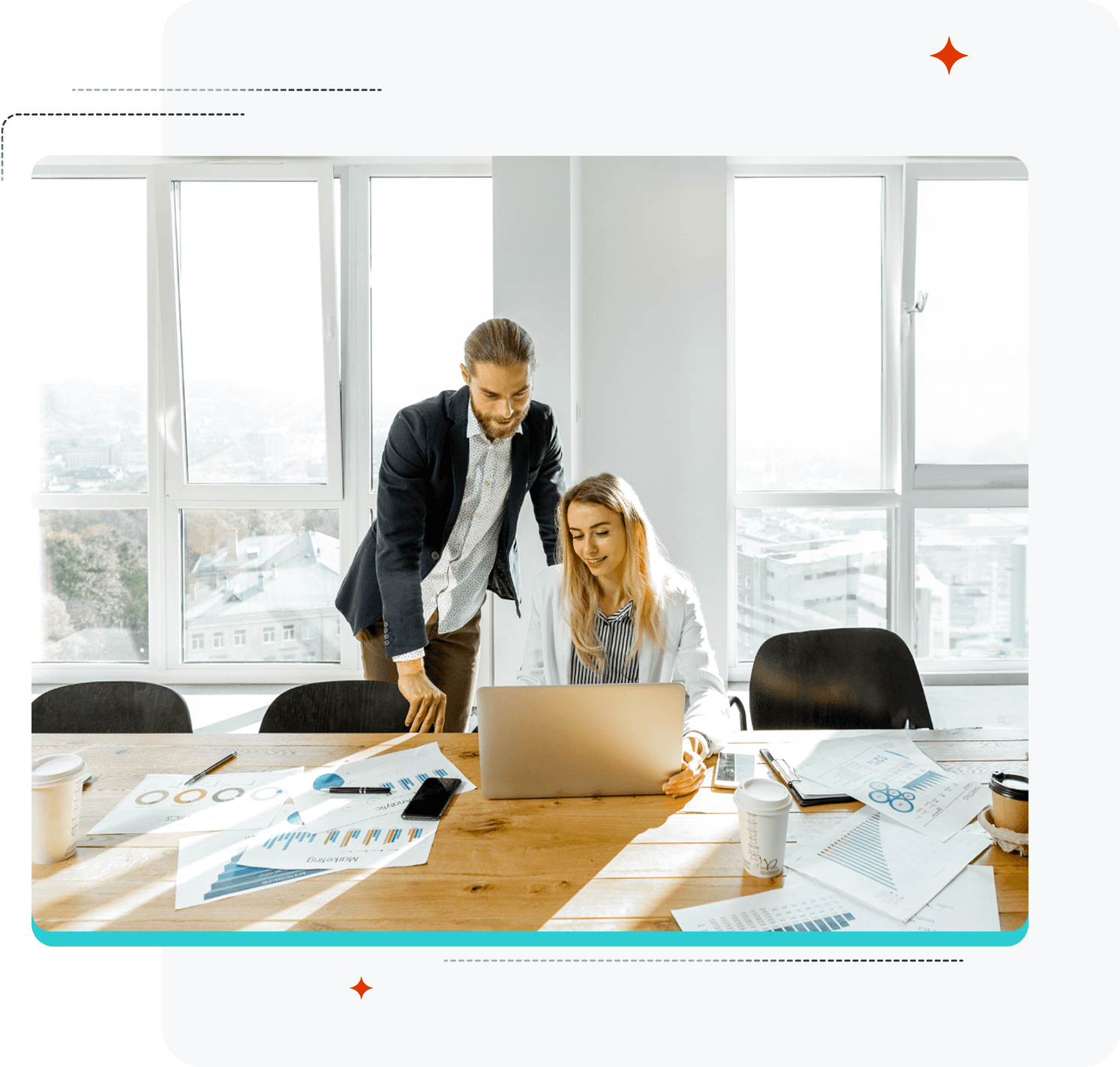 A man and a woman are looking at a laptop.