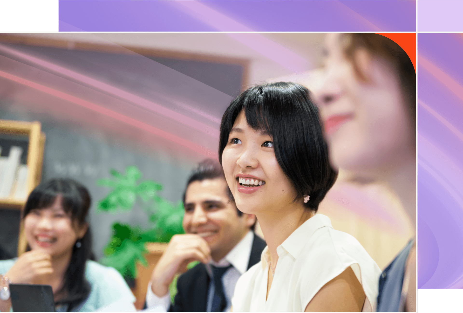 A diverse group of smiling people, with an Asian woman in a white shirt prominently in the foreground.