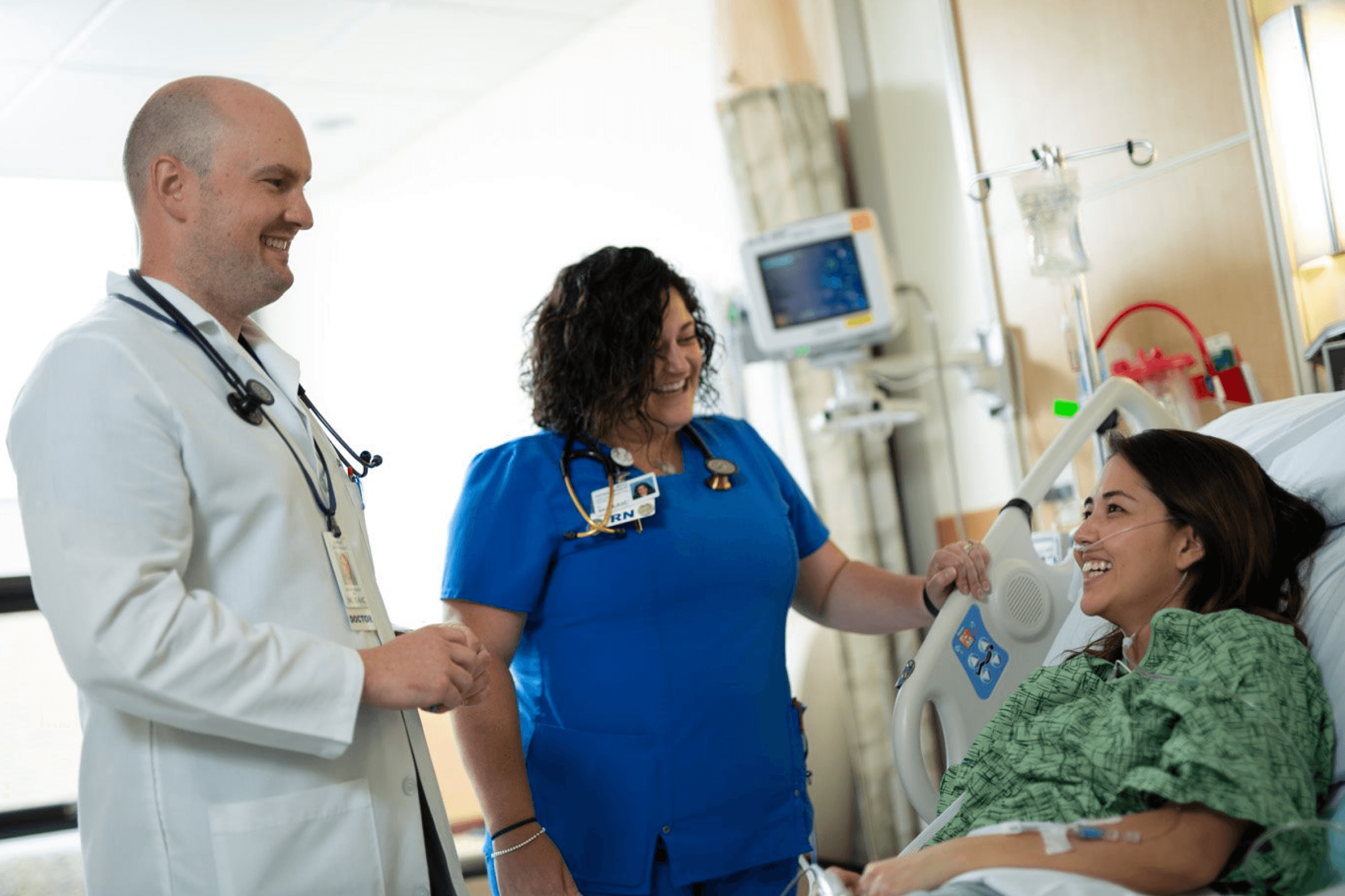 Image of two healthcare workers speaking with a patient.