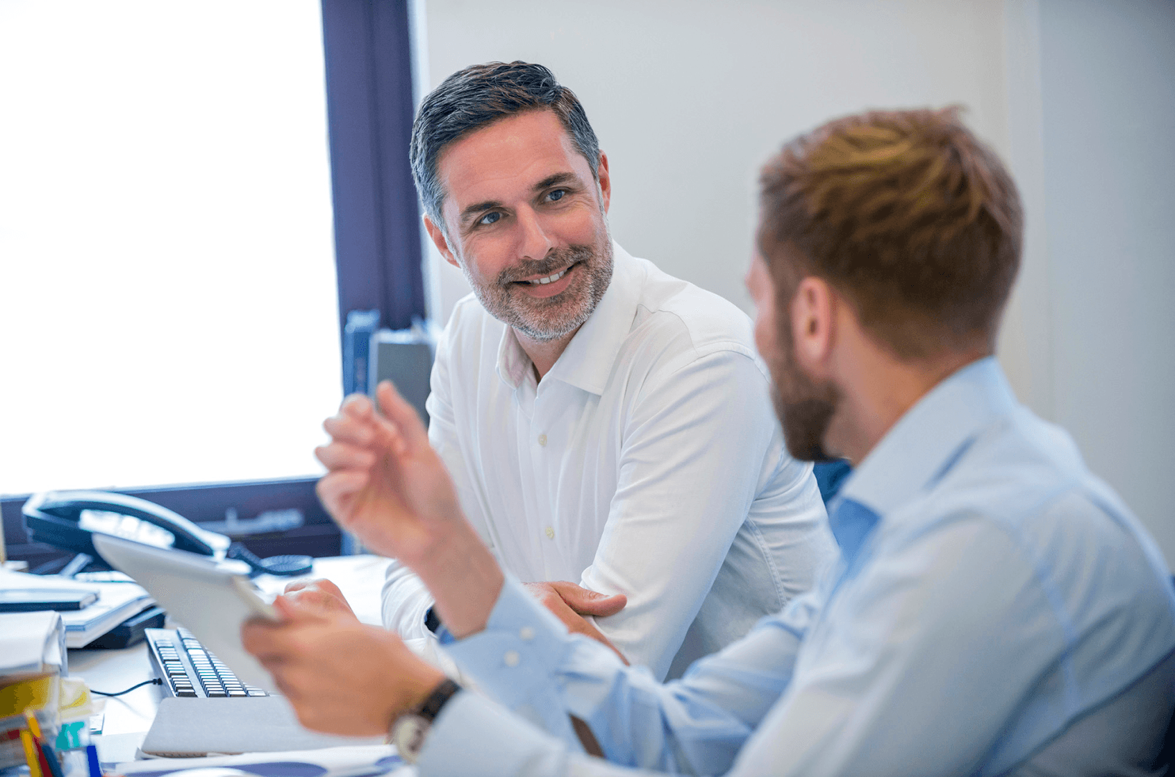 Two men at work having a conversation