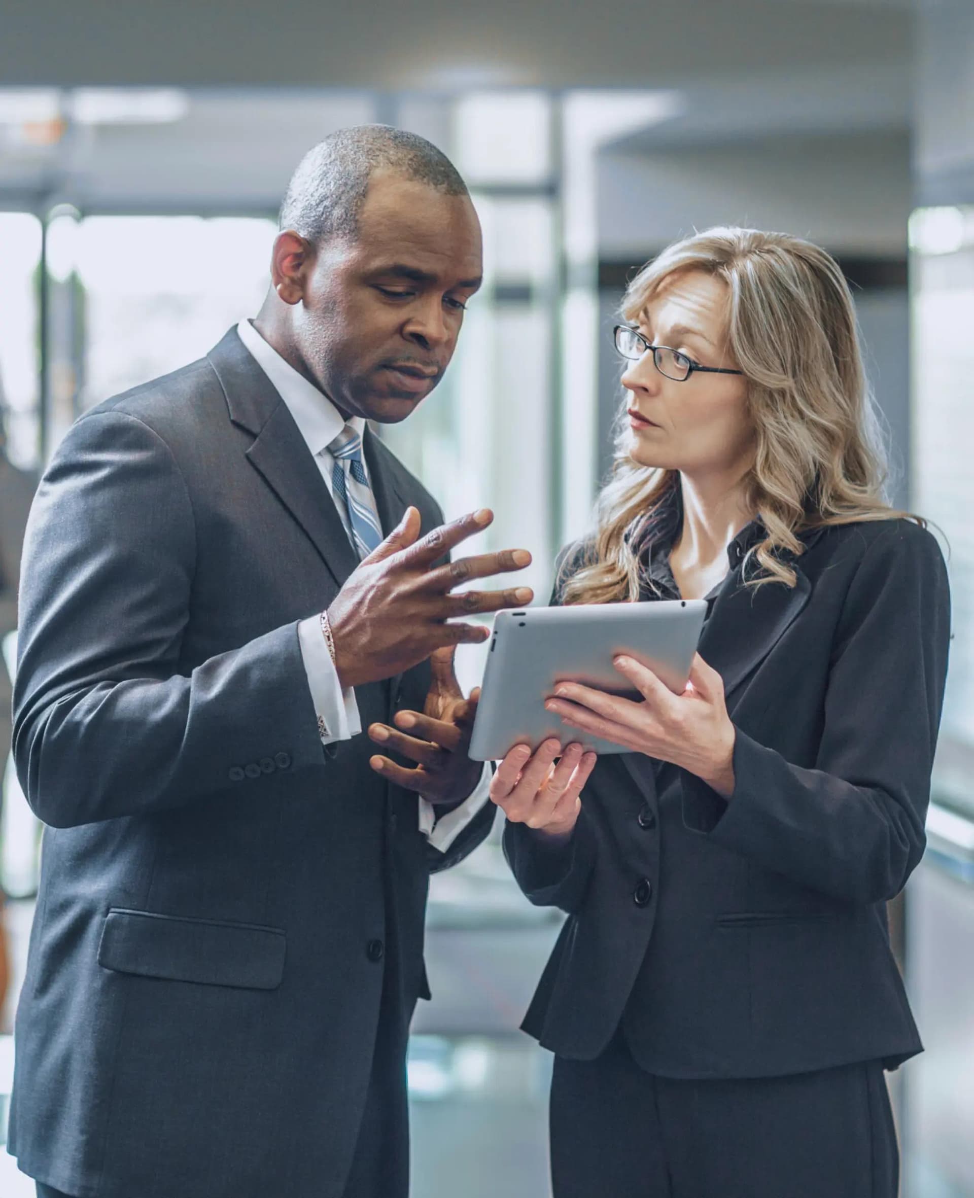 Image of two people reviewing an ipad.